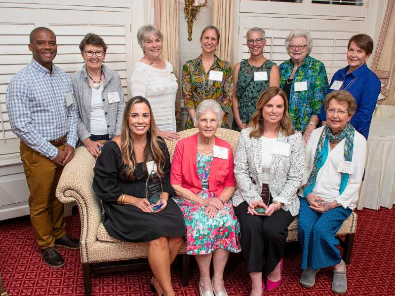 Eleven v.c.u. alumni and school leaders pose for a group photo