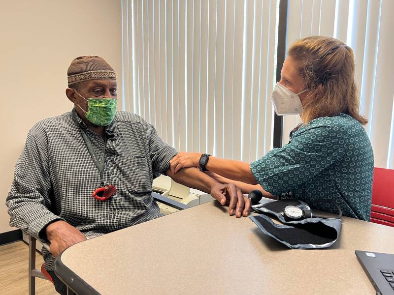 kathie falls, director of clinical operations for m.h.w.p. performs a blood pressure check on a clinic participant