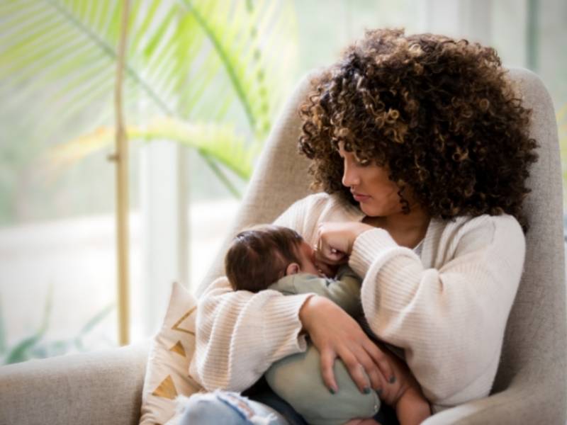 a mother holds her newborn